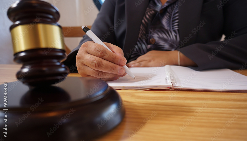 Legal counsel presents to the client a signed contract with gavel and legal law. Justice and lawyer law of advisor Concepts Legal counsel presents to the client a signed contract with gavel and legal law. Justice and lawyer law of advisor Concepts