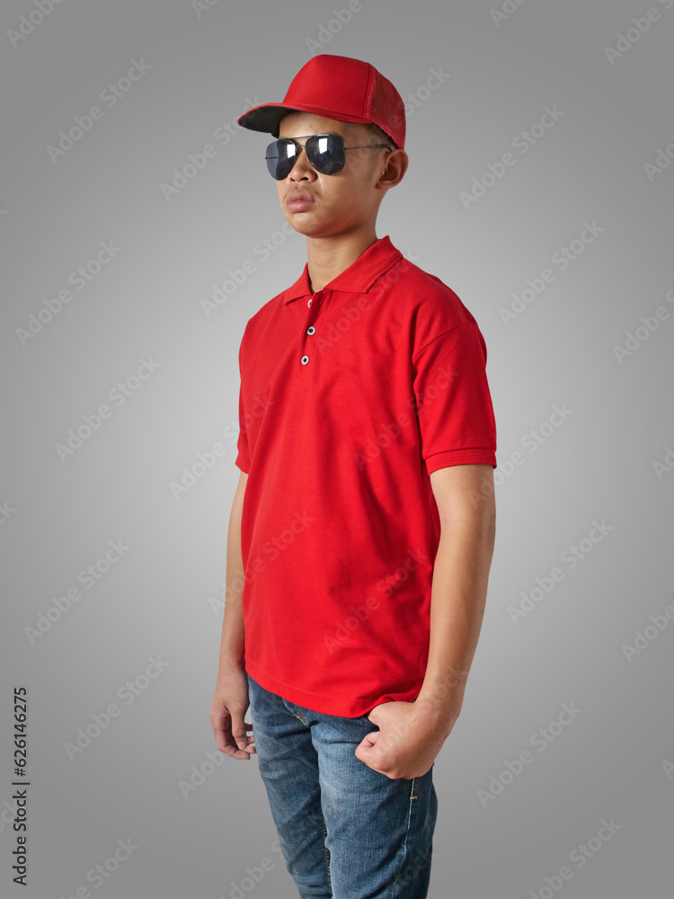 Young Asian teenage boy wearing red collared shirt, hat and sunglasses standing with hands on hip over grey background, t-shirt template Young Asian teenage boy wearing red collared shirt, hat and sunglasses standing with hands on hip over grey background, t-shirt template
