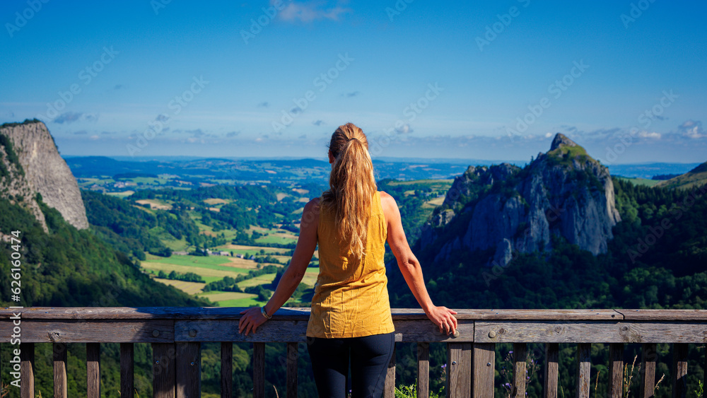 Naklejka premium Woman ooking at beautiful Auvergne landscape panorama in France ( Sanadoire and Tuiliere rocks) Auvergne volcano, Monts Dore mountain