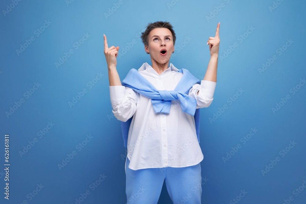 energetic fashionable dark-haired woman in a cool look with a genius proposal points her finger energetic fashionable dark-haired woman in a cool look with a genius proposal points her finger