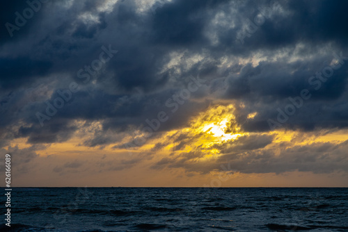 Nice sunset looking through the clouds over the ocean