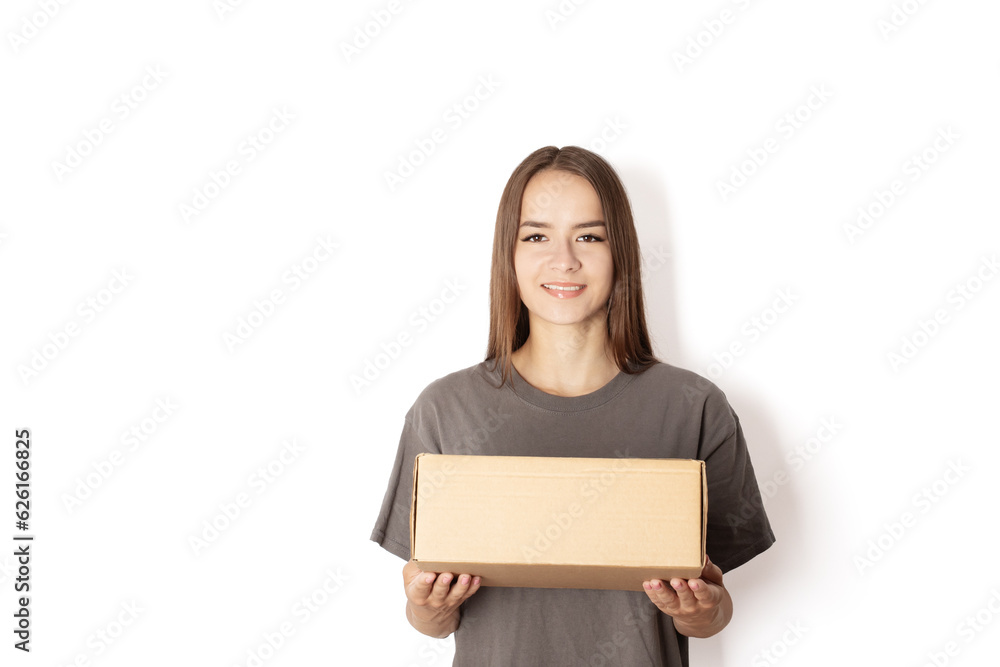 young woman courier with a box parcel on a white background, a teenager girl holds an order in her hands in a package, delivery of goods online young woman courier with a box parcel on a white background, a teenager girl holds an order in her hands in a package, delivery of goods online