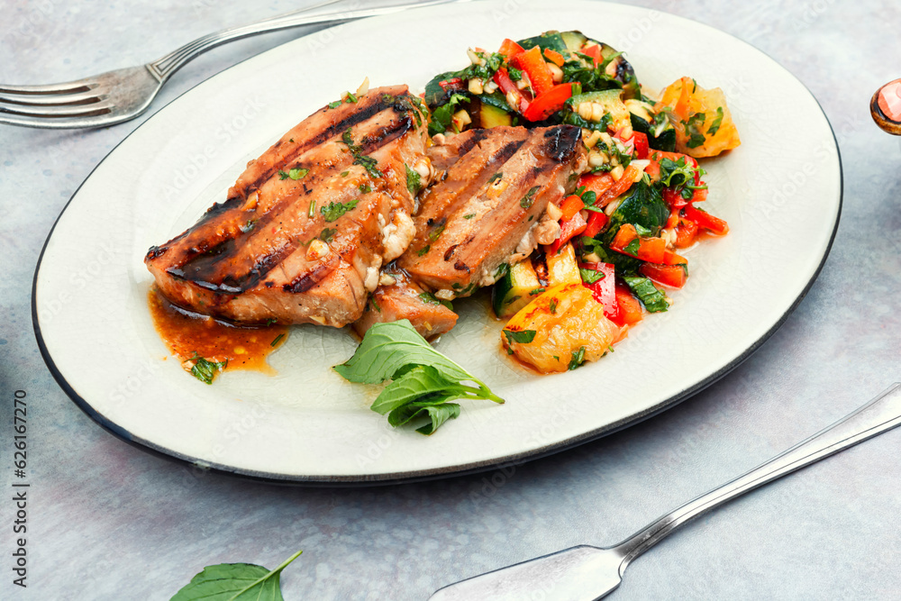 Tuna steak fried with grilled vegetables.
