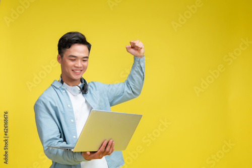 portrait of young businessman standing use computer.
