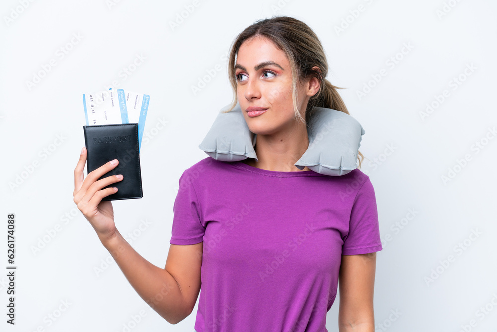 Young pretty Uruguayan woman with Inflatable Travel Pillow isolated on white background looking to the side Young pretty Uruguayan woman with Inflatable Travel Pillow isolated on white background looking to the side