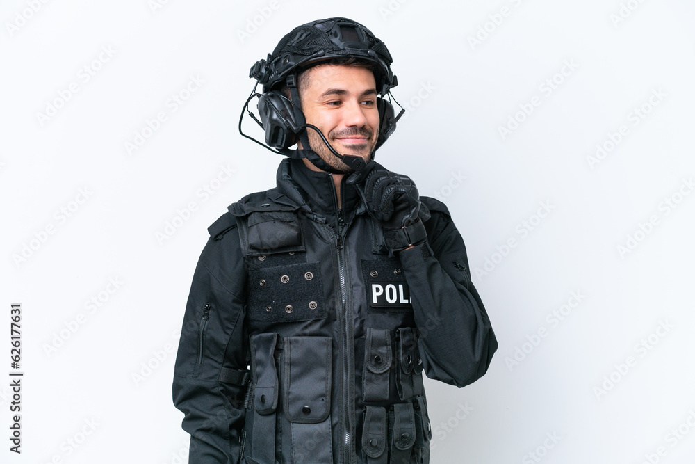Young caucasian SWAT man isolated on white background looking to the side