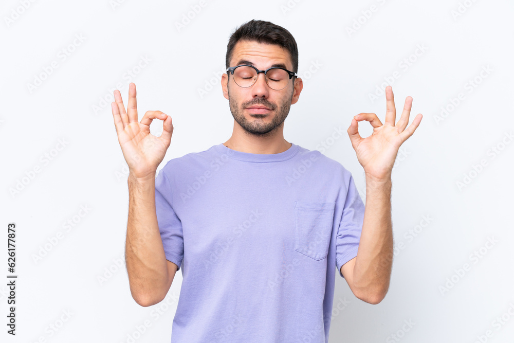 Young caucasian man isolated on white background in zen pose Young caucasian man isolated on white background in zen pose