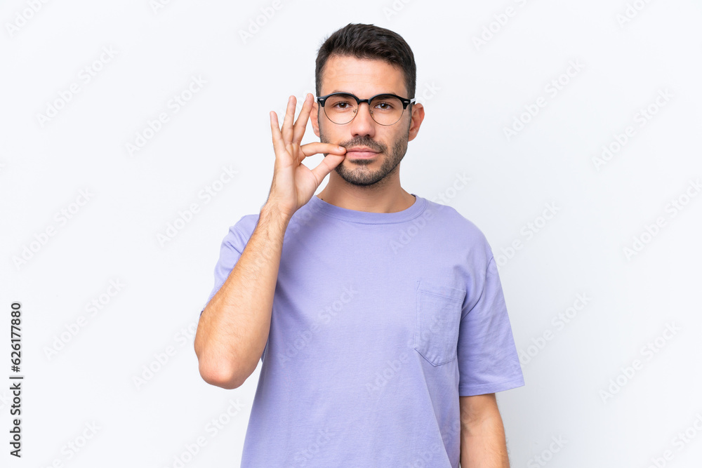 Young caucasian man isolated on white background showing a sign of silence gesture Young caucasian man isolated on white background showing a sign of silence gesture