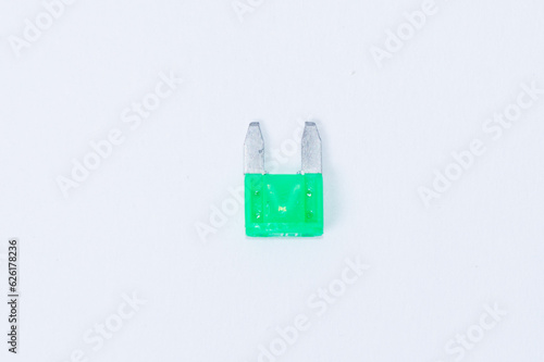 Green electric car fuse isolated on white background