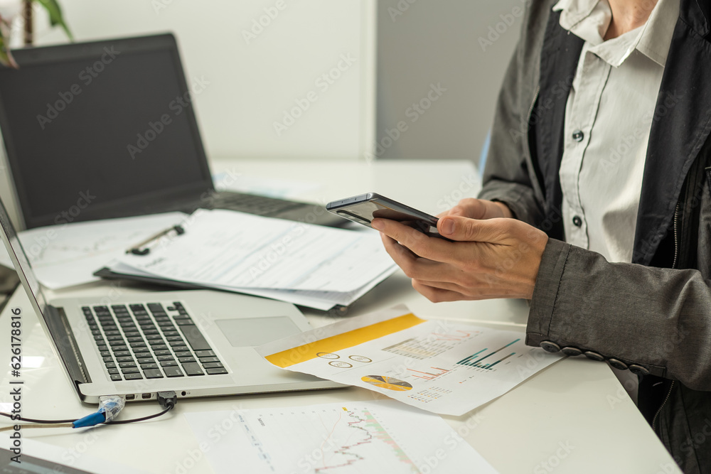 Happy successful busy caucasian man in a suit, company employee, top manager, boss, sitting in the office, talking on the phone with a colleague or client, resolves work issues, smiling Happy successful busy caucasian man in a suit, company employee, top manager, boss, sitting in the office, talking on the phone with a colleague or client, resolves work issues, smiling