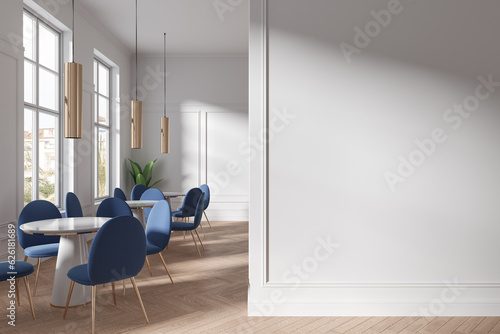 Modern cafe interior with chairs and table in row near window. Mock up wall