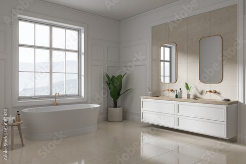 Classic hotel bathroom interior with bathtub and double sink, window © ImageFlow
