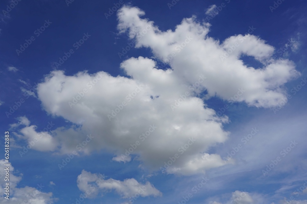 A blue sky background with cumulus white clouds in the sky. A blue sky background with cumulus white clouds in the sky.