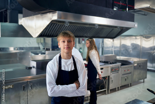 Wallpaper Mural Portrait of student boy in chef uniform in real kitchen classroom. Torontodigital.ca