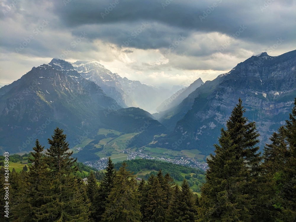 Farm near the Fronalp above Mollis Glarus. Dramatic evening mood. Wanderlust in the Swiss mountains.View of the Klöntal. High quality photo Farm near the Fronalp above Mollis Glarus. Dramatic evening mood. Wanderlust in the Swiss mountains.View of the Klöntal. High quality photo