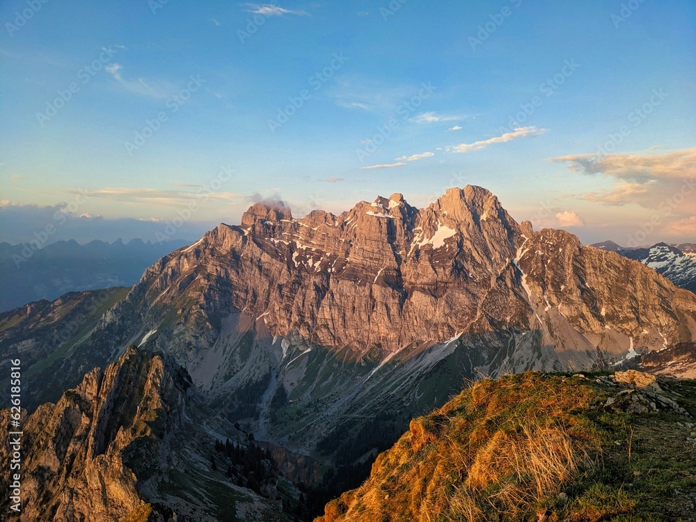 Hike to the Fronalpstock with a view of the Mürtschenstock in Glarus. Beautiful evening mood in the Swiss mountains. High quality photo