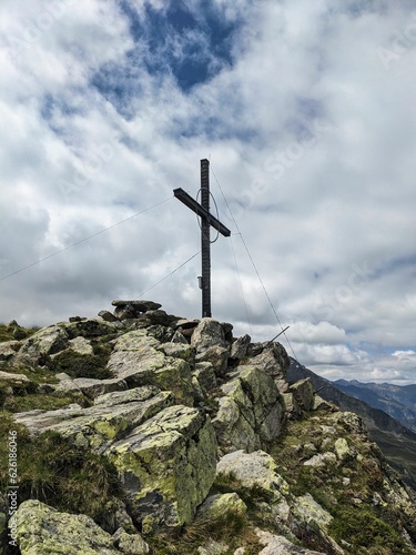 Summit cross on the Hauerkogel mountain in Austria above Langenfeld near Solden. Super nice view. High quality photo. photo