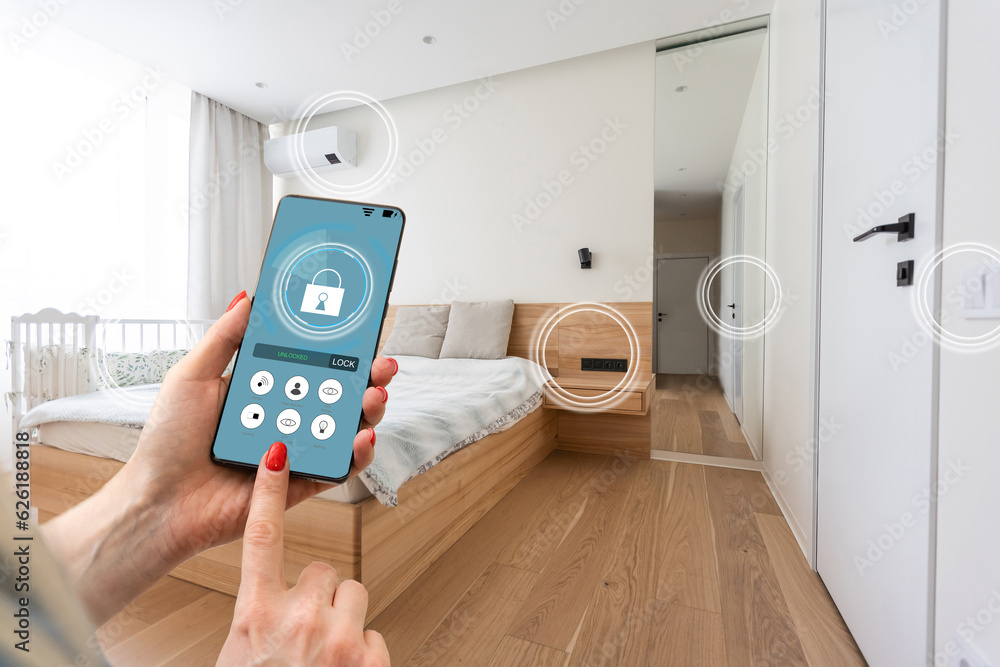 Smart home technology interface on smartphone app screen with augmented reality (AR) view of internet of things (IOT) connected objects in the apartment interior, person holding device. Smart home technology interface on smartphone app screen with augmented reality (AR) view of internet of things (IOT) connected objects in the apartment interior, person holding device.