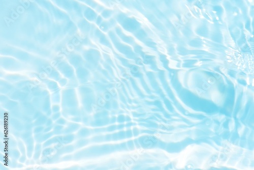 Blue water with ripples on the surface. Defocus blurred transparent blue colored clear calm water surface texture with splashes and bubbles. Water waves with shining pattern texture background. © Water 💧 Shining 📸