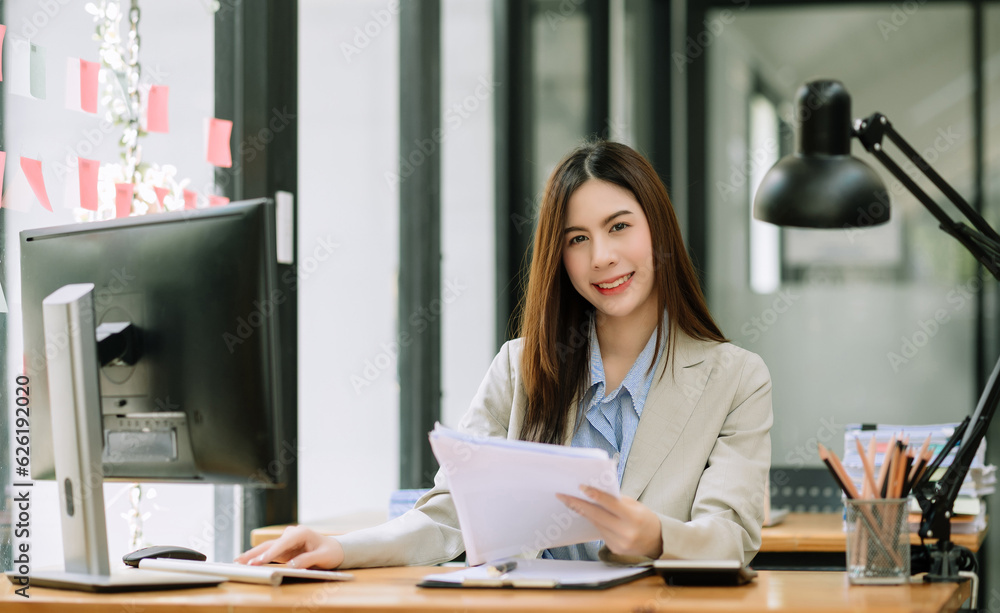 Confident business expert attractive smiling young woman holding digital tablet on desk in office.. Confident business expert attractive smiling young woman holding digital tablet on desk in office..