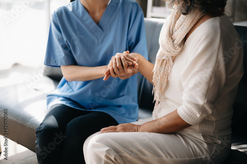 Asian female hands touching old female hand Helping hands take care of the elderly concept..