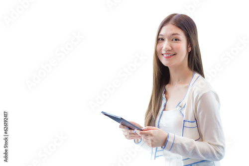 Professional young age Asian business woman with long hair in white shirt holds tablet her smiling happily while she sits on chair in workplace office.