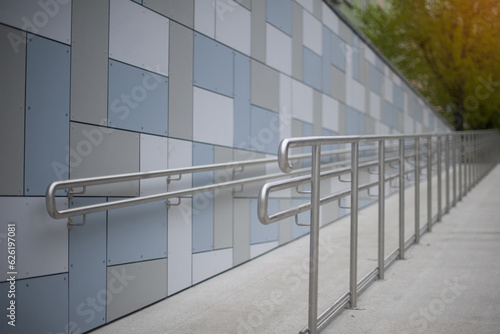 Stainless steel handrails in front of a modern building for the disabled