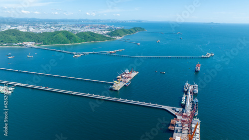 Cargo container Ship running on Bridge Cargo Shipyard. Container ship under the crane Sea Port service logistics and transportation. International Shipping Depot Customs Port for import export trading