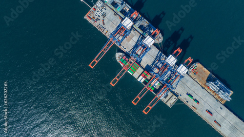 Cargo container Ship running on Bridge Cargo Shipyard. Container ship under the crane Sea Port service logistics and transportation. International Shipping Depot Customs Port for import export trading