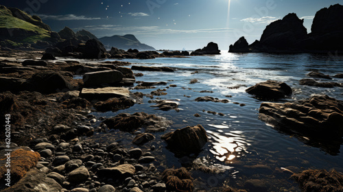 A moonlit scene of a harsh coastline, the jagged rocks casting long shadows on the restless sea.