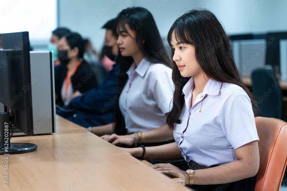 Asian college students attending computer class Asian college students attending computer class