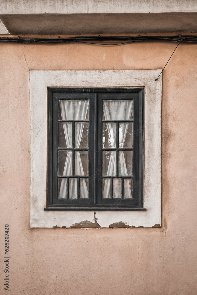 Close-up of old traditional Portuguese window with beautiful textile white curtains