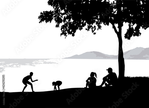 Silhouette of a family on the seashore.