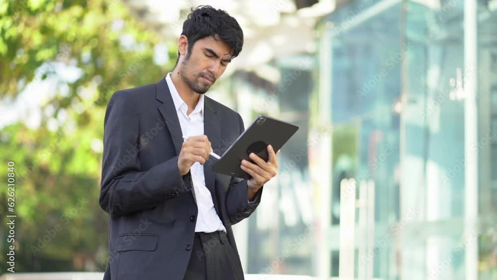 Businessman with digital tablet In hands posing at office, successful businessman using tablet computer. Work place. Lifestyle. Businessman with digital tablet In hands posing at office, successful businessman using tablet computer. Work place. Lifestyle.