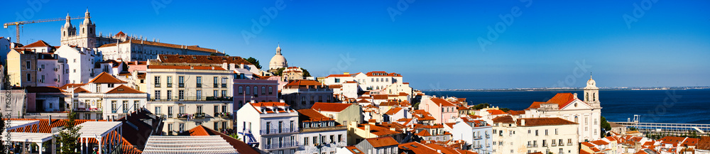 A stunning panoramic view of Lisbon with the river in the background, taken at sunset from the Miradouro da Graça. The city’s historic charm and natural beauty are perfectly captured in this breathtak