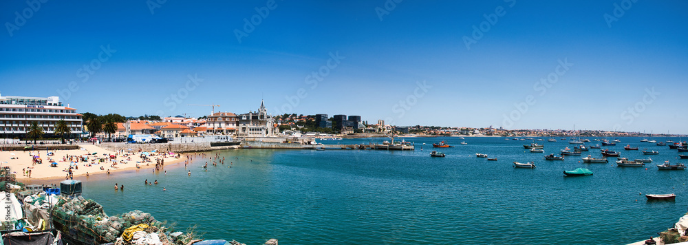 A stunning panoramic view of the picturesque town of Cascais, with its golden sandy beaches and crystal clear waters stretching out into the horizon.