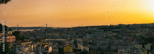 A breathtaking panoramic view of Lisbon at sunset  captured from the Miradouro da Nossa Senhora do Monte. The city   s vibrant colors and historic architecture are beautifully illuminated by the warm gl
