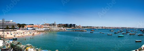 A stunning panoramic view of the picturesque town of Cascais, with its golden sandy beaches and crystal clear waters stretching out into the horizon.