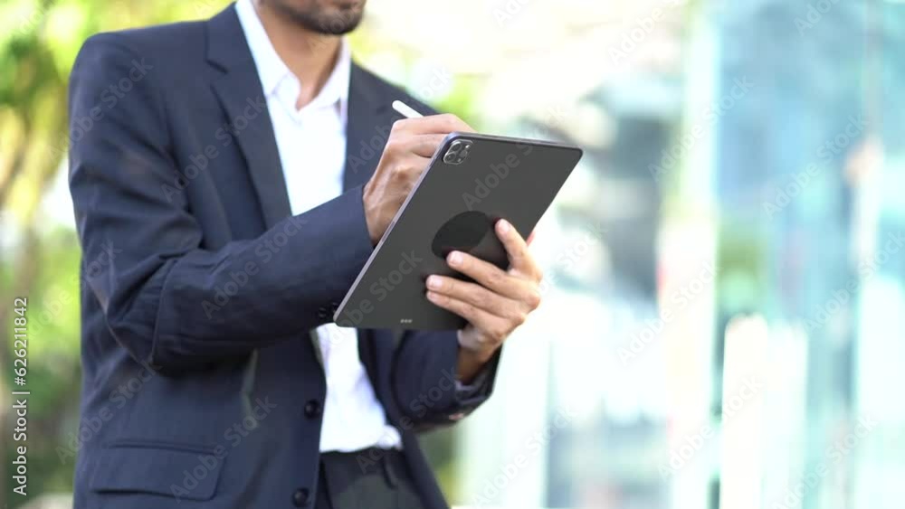 Businessman with digital tablet In hands posing at office, successful businessman using tablet computer. Work place. Lifestyle. Businessman with digital tablet In hands posing at office, successful businessman using tablet computer. Work place. Lifestyle.