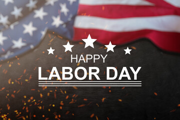 Happy Labor day concept. American flag with different construction tools on dark stone background, with copy space for text.