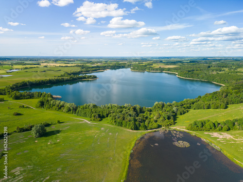 Aerial view of Lake Wuksniki - the deepest lake of the Masurian Lake District, Poland. Landscape of the Warmia region all around