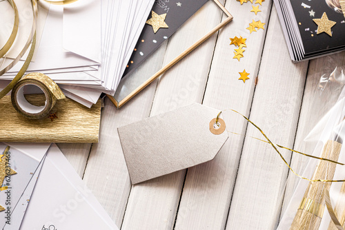 Chic gift wrapping and tags with golden accents and star shapes. Elegant gift wrapping scene featuring golden stars, striped paper, and blank tags ready for personalization