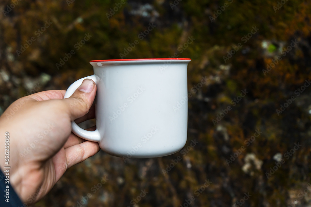 Obraz premium Skillfully arranged for mockup use, the mug complements the natural scenery, artfully arranged with simplicity in mind