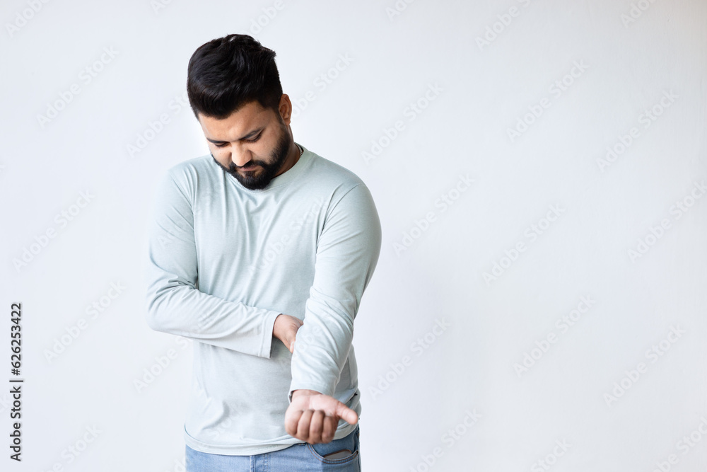 South asian Indian man suffering from elbow joint pain, concept of tennis elbow or golfer’s elbow syndrome, gouty pain, rheumatoid, arthritis, osteoporosis South asian Indian man suffering from elbow joint pain, concept of tennis elbow or golfer’s elbow syndrome, gouty pain, rheumatoid, arthritis, osteoporosis