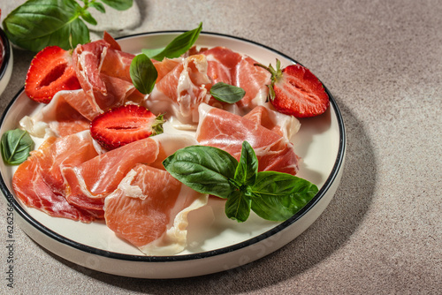 Strawberry with Parma ham jamon. Restaurant menu, dieting, cookbook recipe top view