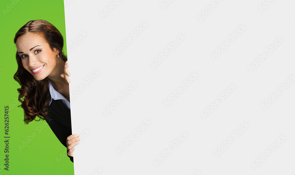 Photo of happy smiling woman in black confident suit, peek out showing mock up white banner signboard with copy space area for sign text. Business and ad concept. Green color background. Photo of happy smiling woman in black confident suit, peek out showing mock up white banner signboard with copy space area for sign text. Business and ad concept. Green color background.