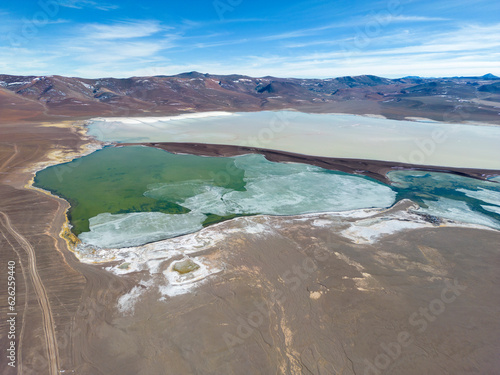 Aerial view of the green and partly frozen Laguna del Negro Francisco in the Atacama desert in Chile - Traveling and exploring South America