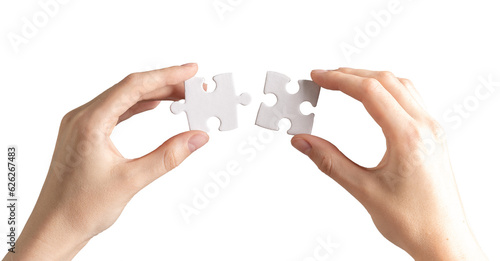 Hand joining, connecting two puzzle pieces together. Business and psychology concept of problem solving, success