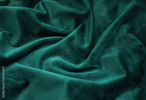 emerald velvet with folds background image, green shiny fabric silk for background web design wallpaper, dark green textile background