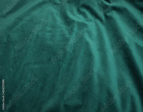 emerald velor with folds background image, green shiny fabric silk for background web design wallpaper, dark green textile background